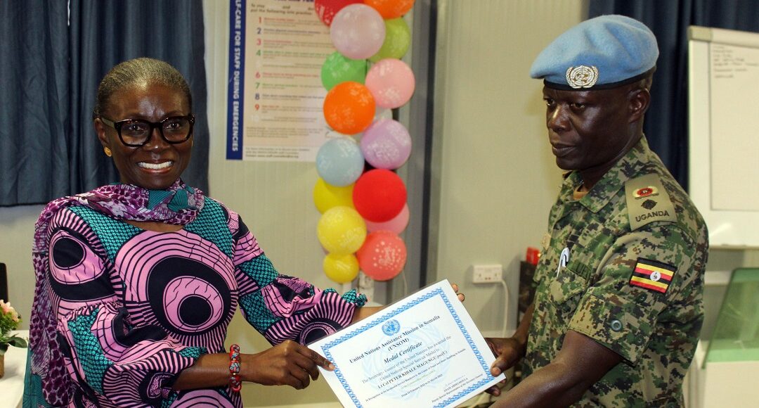 Lt-Col-Peter-Magungu-R-Commander-UNGU-VIII-receiving-a-medal-and-certificate-from-Deputy-Special-Representative-of-the-Secretary-General-UNSOS-HE-Anita-Kiki-Gbeho-L-at-UNGU-City-Somalia-1