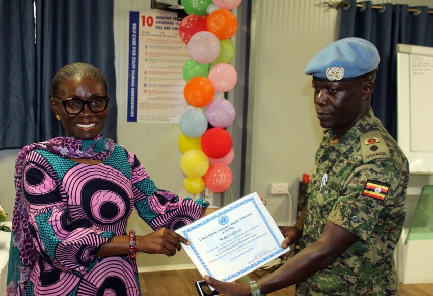 Lt-Col-Peter-Magungu-R-Commander-UNGU-VIII-receiving-a-medal-and-certificate-from-Deputy-Special-Representative-of-the-Secretary-General-UNSOS-HE-Anita-Kiki-Gbeho-L-at-UNGU-City-Somalia-1